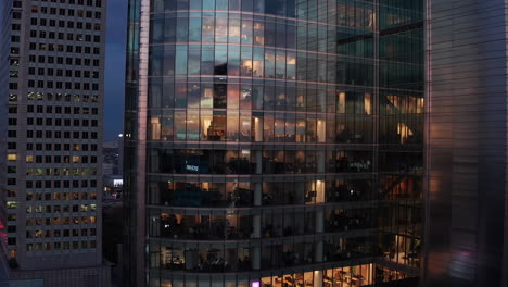Footage-of-modern-futuristic-office-skyscraper-reflecting-sunset-sky.-Large-glass-windows.-Warsaw,-Poland