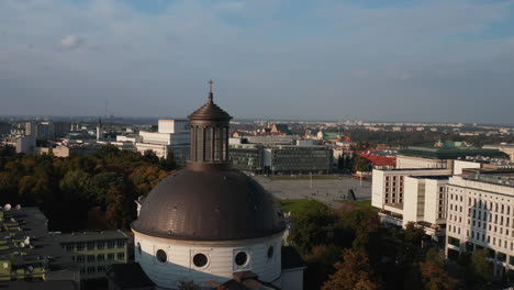 Fly-around-large-brown-dome-roof-of-Holy-Trinity-Church-at-Pilsudski-Square-in-city-centre.-Warsaw,-Poland