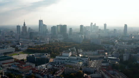 Fly-above-city.-Huge-building-of-Polish-National-Opera-and-modern-Metropolitan-office-building.-Downtown-skyscrapers-in-background.-Warsaw,-Poland