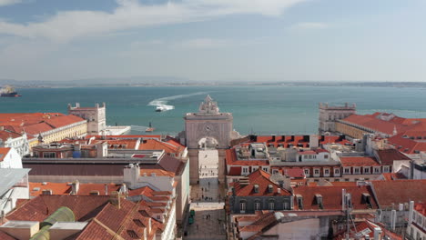 Aerial-dolly-in-view-of-Arco-da-Rua-Augusta-in-Praca-do-Comercio-public-square-with-sea-in-the-background-in-the-city-center-of-Lisbon