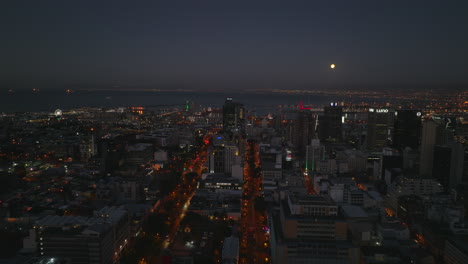 Long-straight-and-wide-streets-surrounded-by-tall-office-buildings.-City-centre-and-seaport-at-night.-Cape-Town,-South-Africa