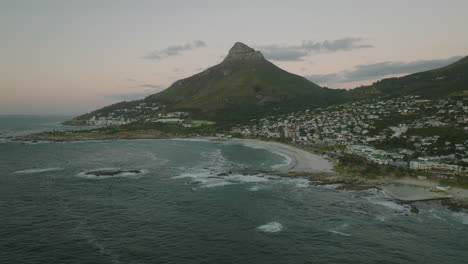 Aerial-panoramic-view-of-sea-coast-in-vacation-destination-at-twilight.-Lions-Head-Mountain-Towering-high-above-shore.-Cape-Town,-South-Africa