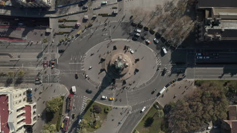 Top-down-ascending-footage-of-Columbus-Monument.-Vehicles-passing-on-multilane-roads-around-famous-landmark.-Barcelona,-Spain