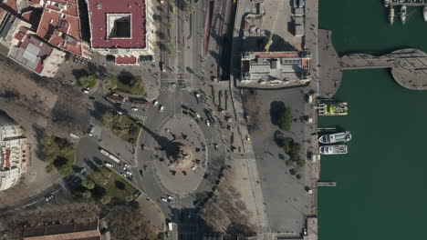 Top-down-panning-footage-of-famous-Columbus-Monument-and-multilane-road-along-waterfront.-Barcelona,-Spain