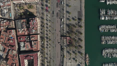 Top-down-shot-of-waterfront-with-Moll-de-Bosch-i-Alsina-pedestrian-zone-in-Port-Vell-in-centre-city.-Barcelona,-Spain