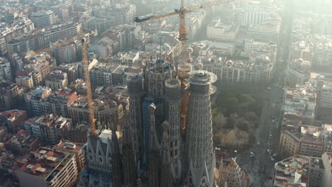 Aerial-ascending-footage-of-top-of-construction-site-of-basilica-Sagrada-Familia.-Famous-tourist-attraction.-Barcelona,-Spain