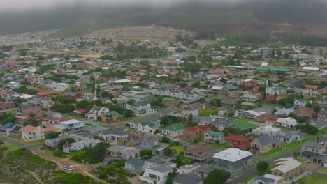 Aerial-panoramic-footage-of-buildings-in-rectangular-street-network-of-Kleinmond-town.-Family-houses-with-colour-roofs.