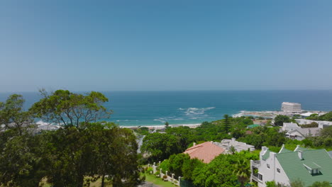 Forwards-fly-above-calm-residential-borough-with-nice-view-of-sea.-Luxury-residencias-and-vacation-houses.-Plettenberg-Bay,-South-Africa