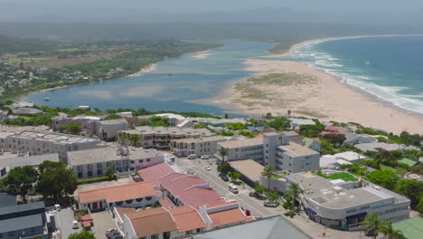 Aerial-footage-of-residential-borough-on-hill-near-seaside.-Buildings-in-coastal-town.-Plettenberg-Bay,-South-Africa