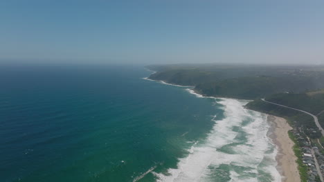 Aerial-panoramic-footage-of-seacoast.-White-waves-along-shore,-water-washing-beaches-or-crashing-to-rocky-coast.-South-Africa