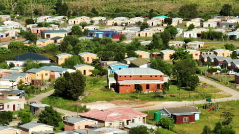 Slide-and-pan-footage-of-small-simple-houses-in-workers-colony.-Group-of-similar-low-buildings-in-suburbs.-South-Africa