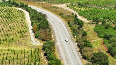 High-angle-view-of-vehicles-driving-on-road-in-landscape.-Backwards-tracking-of-white-van.-South-Africa
