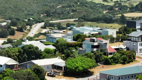 Aerial-footage-of-residencies-in-town.-Parallax-effect-with-buildings-and-green-vegetation-in-background.-South-Africa