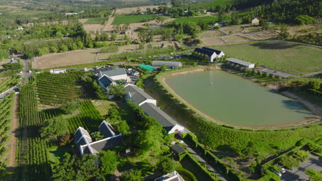 Forwards-fly-above-farm-in-countryside-on-sunny-day.-Large-water-reservoir-for-irrigation.-South-Africa