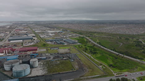 Aerial-panoramic-footage-of-flat-coastal-landscape.-Industrial-site-and-residential-borough-of-large-town.-Port-Elisabeth,-South-Africa