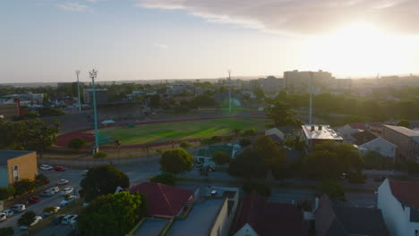 Slide-and-pan-shot-of-sports-area-in-town.-Empty-athletic-stadium-against-setting-sun.-Port-Elisabeth,-South-Africa