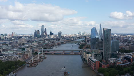 Aerial-view-of-large-modern-city-with-tall-skyscrapers.-Fly-above-River-Thames,-Blackfriars-Bridge-Foreshore-construction-site-at-bank.-London,-UK