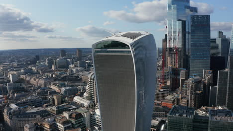 Slide-and-pan-footage-of-new-modern-skyscraper-with-futuristic-design.-Tall-office-buildings-in-City-financial-and-economic-hub.-London,-UK