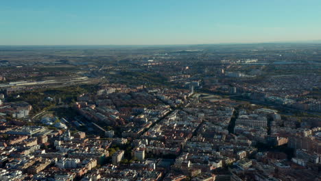 Aerial-panoramic-view-of-urban-neighbourhood-at-golden-hour.-Fly-above-large-metropolis.