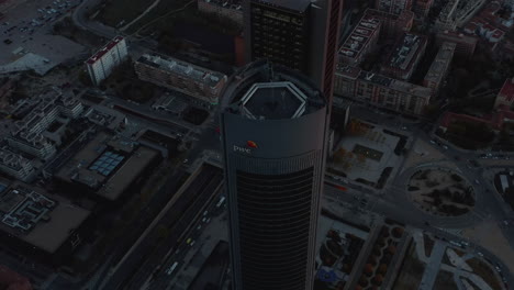 Fly-around-top-of-office-towers-in-Cuatro-Torres-Business-area.-Evening-scene-after-sunset.