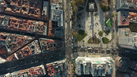 Aerial-birds-eye-overhead-top-down-view-of-traffic-in-streets-around-Plaza-de-Espana.-Rooftop-view-of-buildings-in-town.