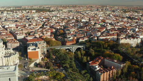 Slide-and-pan-footage-of-historic-Segovia-Viaduct-and-buildings-in-old-town.-Panoramic-view-of-city-in-bright-afternoon-sun.