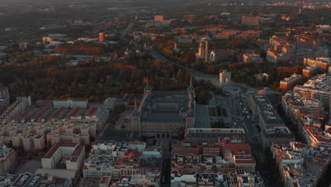 Aerial-footage-of-large-historic-building-of-Ministry-of-Air-and-triumphal-arch-Arco-de-la-Victoria-in-sunset-light.