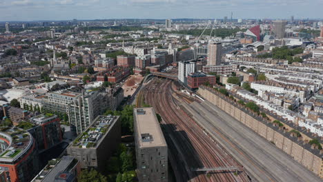 Aerial-view-of-multitrack-railway-line,-Victoria-Light-Maintenance-Depot-and-surrounding-housing-estate.-London,-UK