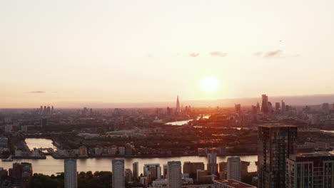 Rising-shot-of-large-town-at-sunset.-Skyline-with-skyscrapers-in-multiple-financial-centres-in-city.-London,-UK