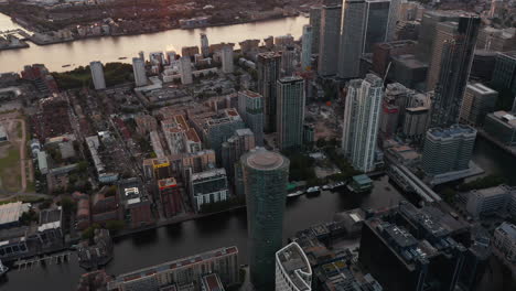 High-angle-view-of-water-channel-between-buildings-at-Canary-Wharf-business-district.-Aerial-view-in-sunset-time.-London,-UK