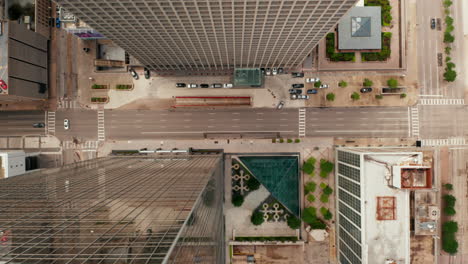 Aerial-birds-eye-overhead-top-down-view-of-wide-multi-lane-downtown-streets-with-low-traffic.-Horizontally-panning-view.-Dallas,-Texas,-US
