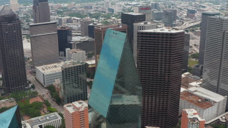 High-angle-view-of-sharp-ridge-on-top-of-tall-glass-covered-unusual-shape-building.-Tilt-down-at-Fountain-place-skyscrapers.-Dallas,-Texas,-US