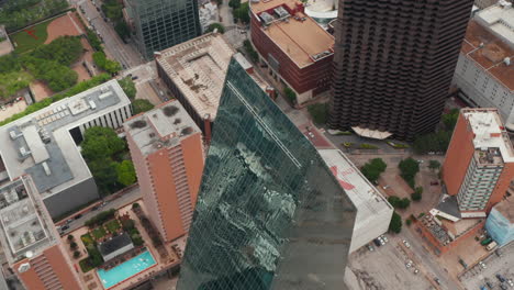 High-angle-view-of-sharp-ridge-on-top-of-tall-glass-covered-unusual-shape-building.-Aerial-drone-view-of-Fountain-place.-Dallas,-Texas,-US
