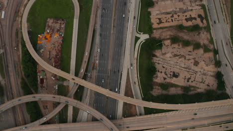 Aerial-birds-eye-overhead-top-down-panning-view-of-large-and-complex-multi-lane-highway-intersection.-Cars-smoothly-driving-in-lanes.-Dallas,-Texas,-US
