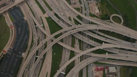 Aerial-birds-eye-overhead-top-down-view-of-large-and-complex-multi-lane-highway-intersection.-Multilevel-transport-construction.-Busy-road-in-rush-hours.-Dallas,-Texas,-US