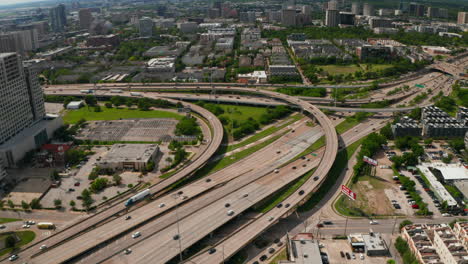 Aerial-view-of-large-multi-lane-highway-intersection-in-town.-Cars-smoothly-driving-in-lanes-through-multilevel-transport-construction.-Dallas,-Texas,-US