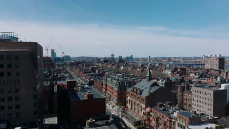 Old-red-bricks-buildings-in-residential-urban-neighbourhood.-Fly-above-city-on-sunny-day.-Boston,-USA