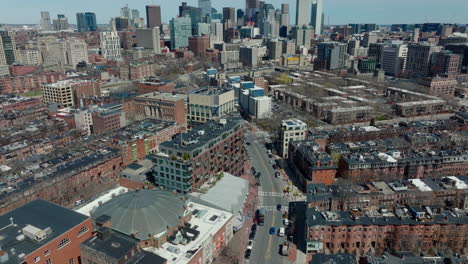 High-angle-view-of-urban-borough-with-cyclorama-building.-Tilt-up-reveal-cityscape-with-downtown-skyscrapers.-Boston,-USA