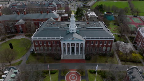 Aerial-descending-shot-of-Baker-Library-building.-Beautiful-brick-building-with-white-tower.-Boston,-USA