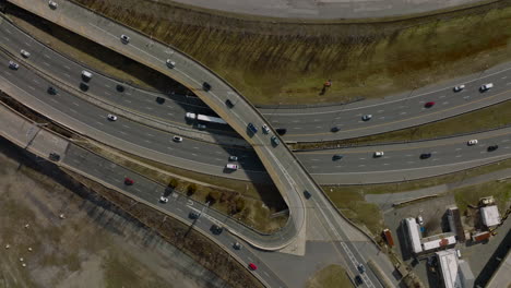 Top-down-footage-of-busy-highway-interchange.-Multilane-and-multilevel-crossroad-with-heavy-traffic.-Boston,-USA