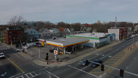 Aerial-view-of-modern-gas-station-in-city.-Motorist-services-at-crossroad-in-residential-urban-borough.-Boston,-USA