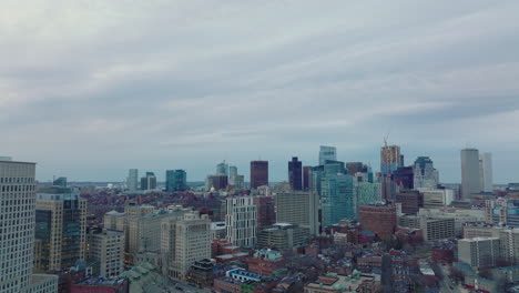 cityscape-view-downtown-skyscrapers-against-grey-cloudy-sky.-Forwards-fly-above-city-ad-dusk.-Boston,-USA