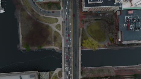 Birds-eye-shot-of-traffic-in-city.-Long-queue-of-cars-on-multilane-road-and-bridge-over-river.-Boston,-USA