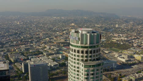 AERIAL:-Close-up-of-US-Bank-Skyscraper-Top,Helipad-in-Downtown-Los-Angeles,-California-with-beautiful-sunlight,blue-sky,