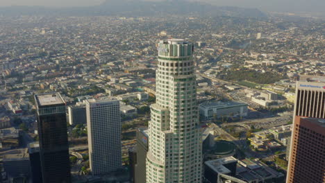 AERIAL:-Close-up-of-US-Bank-Skyscraper-Top,Helipad-in-Downtown-Los-Angeles,-California-with-beautiful-sunlight,blue-sky,