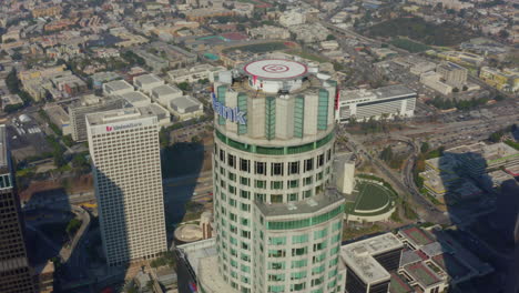 Medium-Shot-of-iconic-famous-Skyscraper-Building-in-Downtown-Los-Angeles,-California-Skyline-in-blue-sky-Daylight,-Aerial-slide-left-establisher
