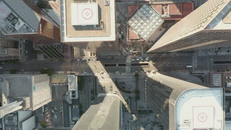 Downtown-Area-of-big-city-view-on-main-road-through-skyscrapers-with-little-car-traffic-due-to-Covid-19-Coronavirus-Pandemic-Lockdown-restrictions,-Aerial-Birds-Eye-Overhead-View