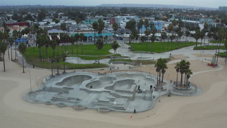 Above-almost-empty-Venice-Beach-Skate-due-to-Coronavirus-Lockdown-Park-near-Los-Angeles-Beach,-Aerial-wide-angle-Shot