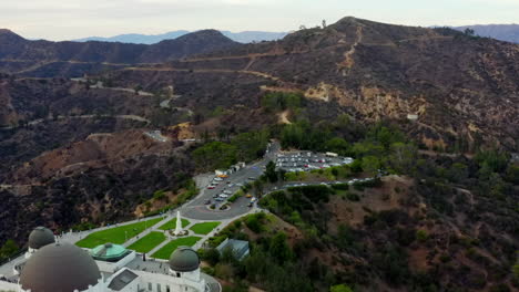 AERIAL:-Over-Griffith-Observatory-with-Hollywood-Hills-in-Daylight,-Los-Angeles,-California,-Cloudy