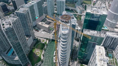 High-angle-view-of-skyscraper-construction-site.-Top-down-view-of-modern-city.-Glittering-water-surface.-Miami,-USA